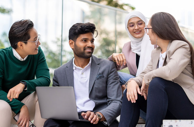 Group of people sitting on a building's steps and discussing changes they are advocating for
