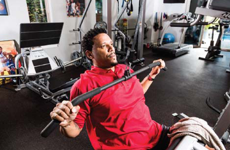 Brian Grant lifting weights in a gym