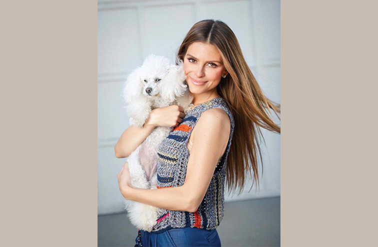 Maria Menounos pictured holding a dog.