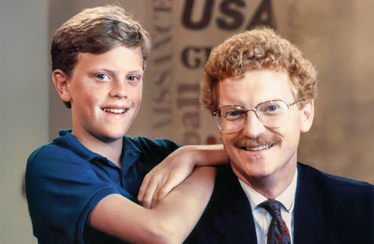 A young Willie Geist leans on his seated father Bill.