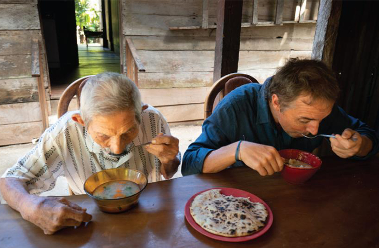 Dan Buettner enjoying butternut squash soup with a Nicoyan centenarian