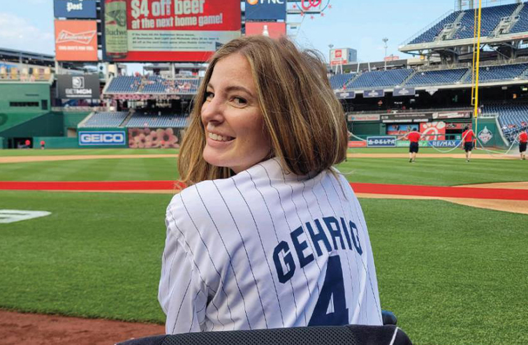 Brooke Eby in a baseball jersey on the field at a Washington Nationals game.