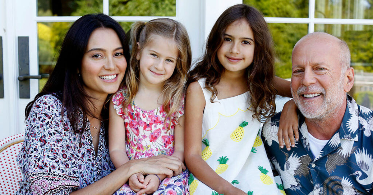Emma Heming Willis and Bruce Willis pose with two of their children outdoors.